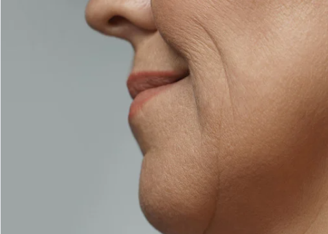 A woman with a small neck and a petite nose, showcasing her delicate facial features.